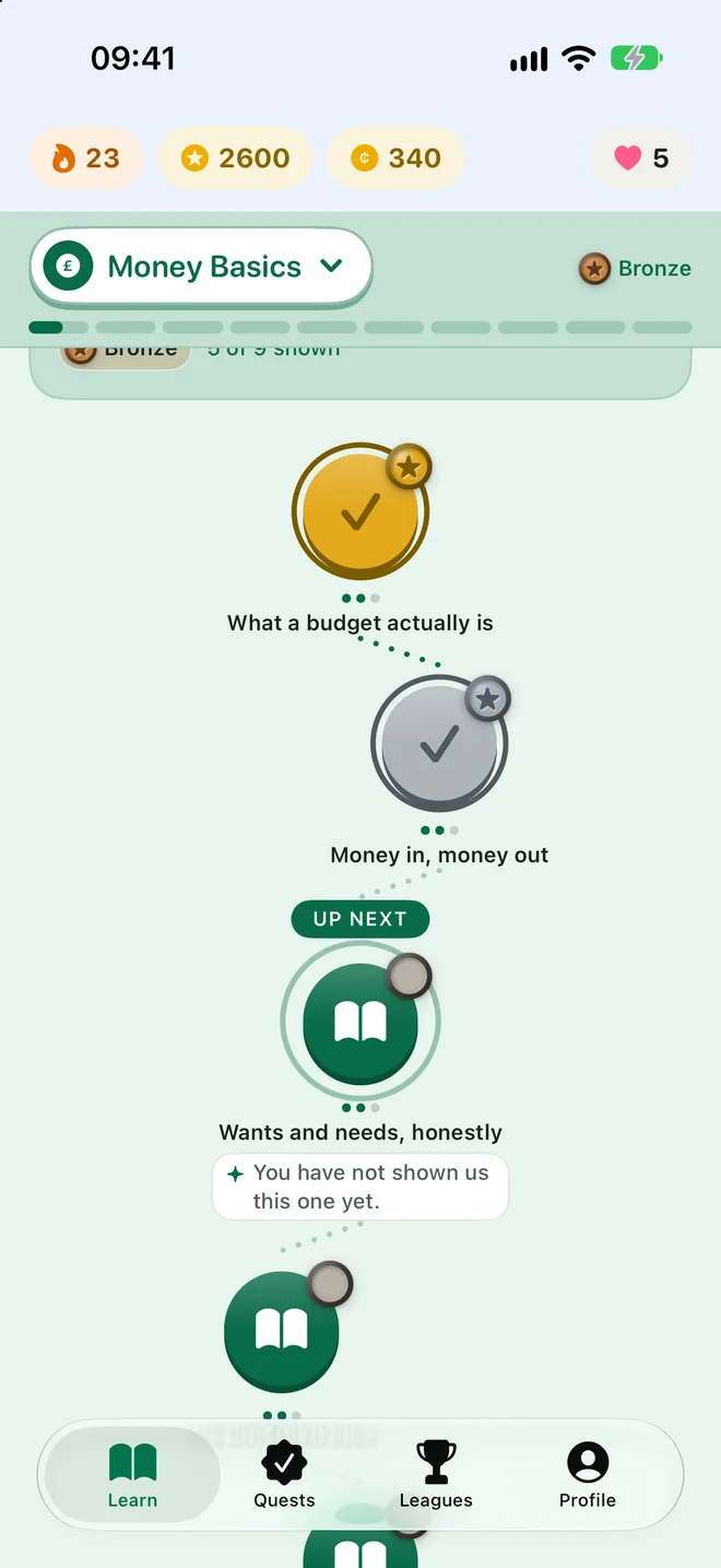 Ledgerly's Path view: Money Basics lessons winding down the screen, with the streak and Pennies at the top